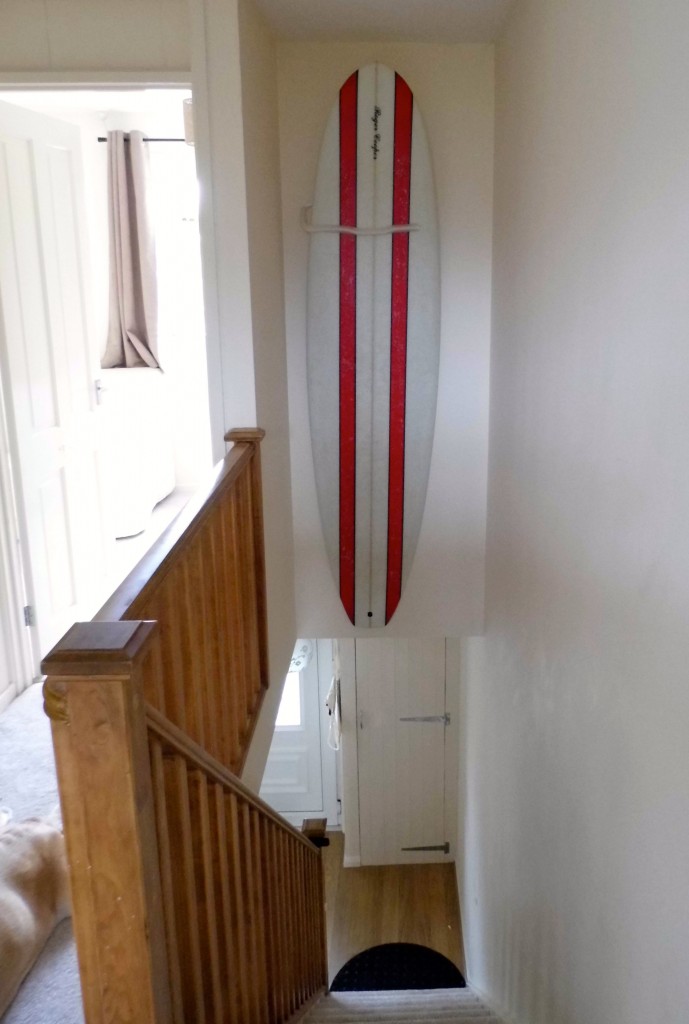 Surfboard mounted in staircase